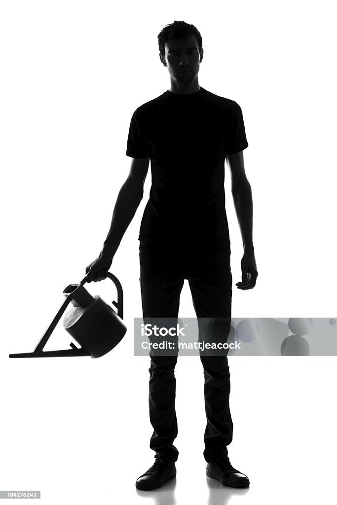 Gardening Male figure with a watering can In Silhouette Stock Photo