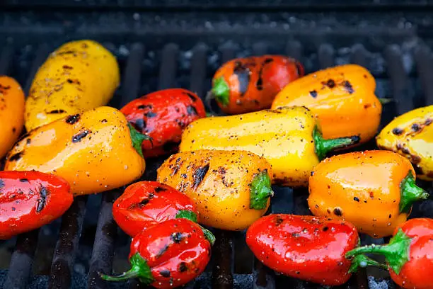 Colorful little roasted peppers on the grill.