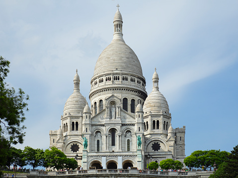 Tourists at the front of the Basilica of Sacré Coeur de Montmartre (Sacred Heart of Montmartre), commonly known as Sacré-Cœur Basilica