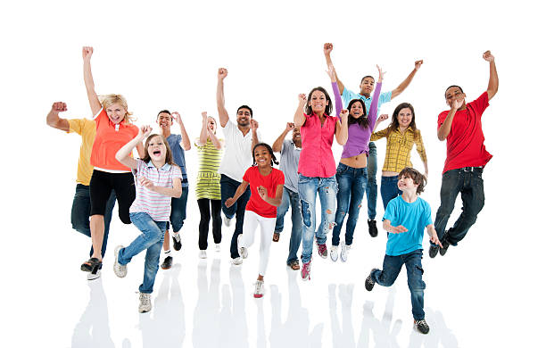 Large group of people jumping. Front view of a large group jumping. They are isolated on the white background and looking at the camera. jumping teenager fun group of people stock pictures, royalty-free photos & images