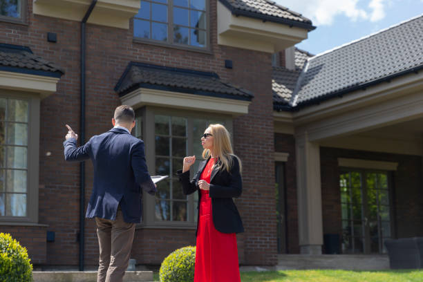 istock Blonde customer inspects cottage residence with agent 1842780900