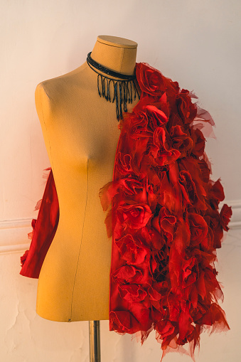 Red fashion coat hanging on a mannequin. Stylish and fashion concept