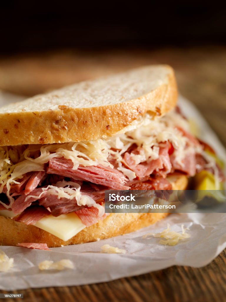 Pastrami Sandwich "Pastrami Sandwich on Rye Bread with Swiss Cheese, Sauerkraut, Mustard and a side of Potato Chips-Photographed on Hasselblad H3D2-39mb Camera" Corned Beef Stock Photo
