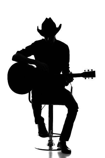 Cowboy silhouette with acoustic guitar