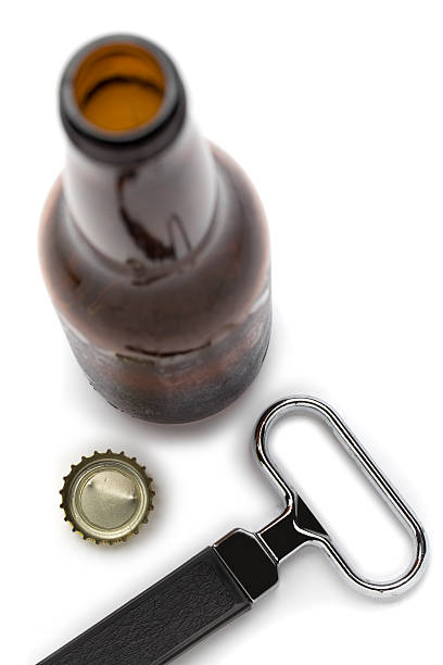 Beer Bottle and Opener Beer Bottle, bottle cap and Opener isolated on white. opening bottle cap photos stock pictures, royalty-free photos & images