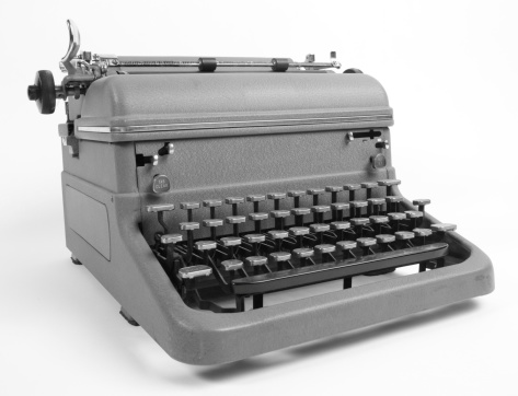An antique, black, manual Hebrew typewriter in poor condition following years of use.