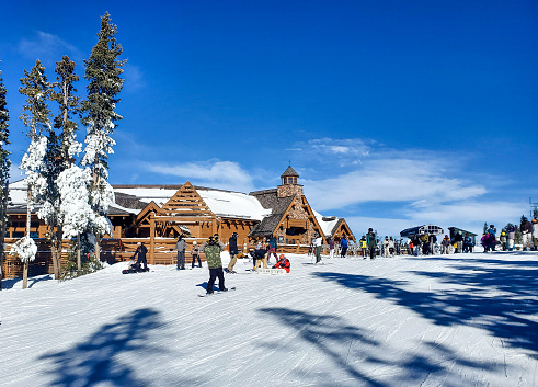 Winter Park, Colorado, USA- December 5, 2023: People outside the on mountain Sunspot lodge at Winter Park ski resort, Colorado.