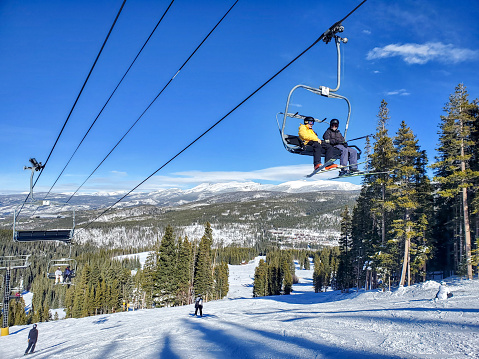 Winter Park, Colorado, USA- December 5, 2023:Looking up at people on the Explorer Express ski lift. Winter Park, Colorado.
