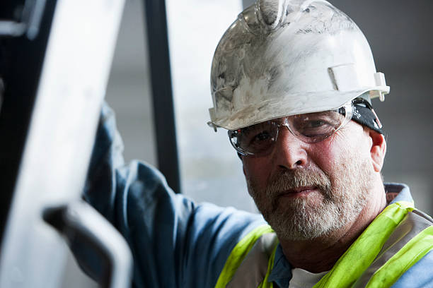 Manual worker in hard hat and safety glasses