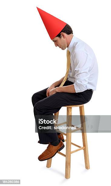 Business Man With A Dunce Hat Stock Photo - Download Image Now - Dunce Cap, Red, 30-39 Years