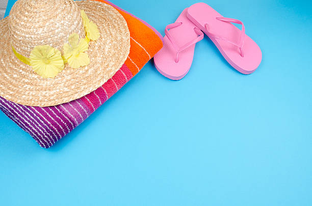 istock Flip-flops with sun hat and beach towel 184280519