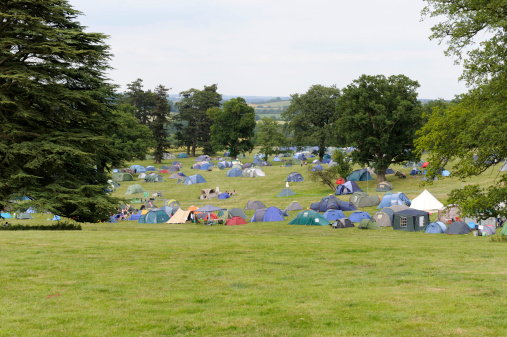Campsite for tents at a summer music festival in an Oxfordshire parkland.