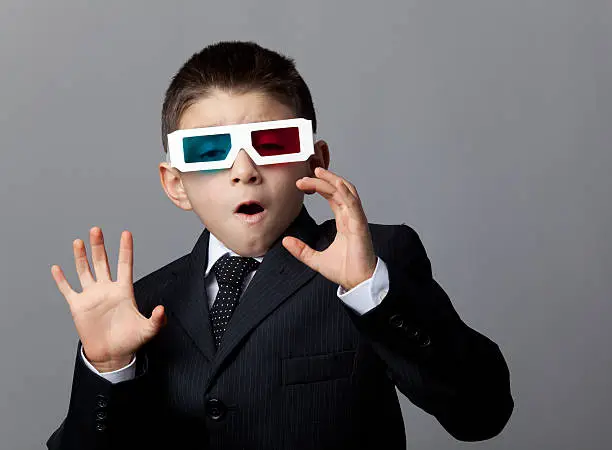 Photo of Excited child with 3-D glasses watching three-D film