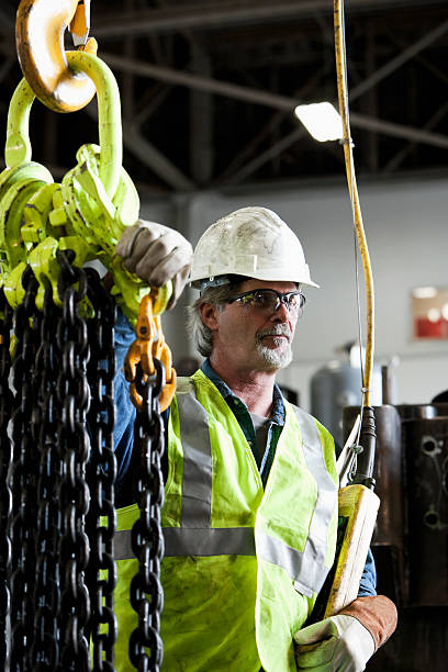 istock Worker in factory with industrial hook and chains 184281317
