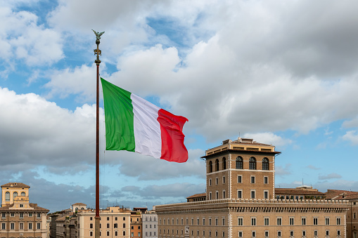Italian flag with buildings in Rome