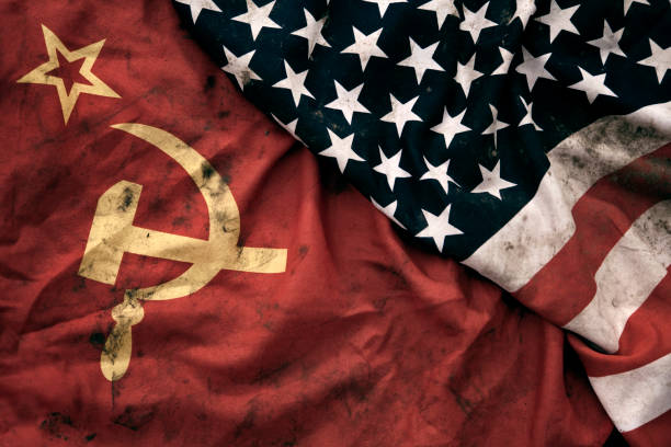 Grungy Flags of Soviet Union and USA Low key photography of grungy old Soviet Union and United States of America flags. USSR, CCCP, USA. former soviet union stock pictures, royalty-free photos & images
