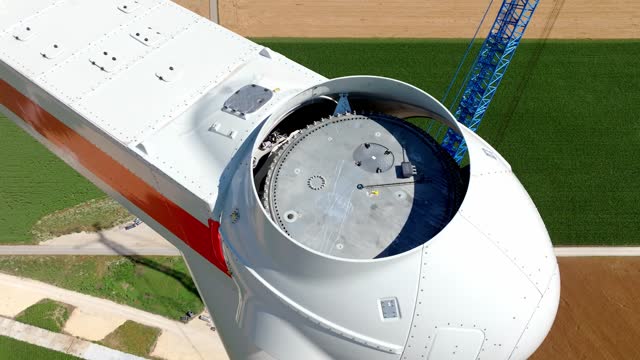 The Head of a Wind Turbine Under Construction - Orbit Drone Shot