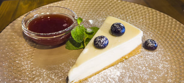 istock vanilla cheesecake with blueberries, mint leaves, strawberry jam, powdered sugar 1842822391