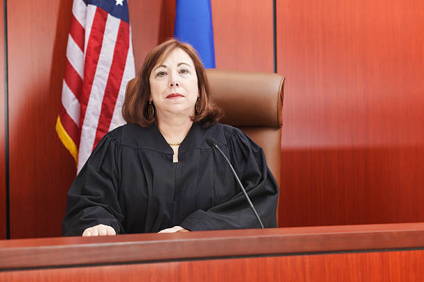 Female Judge Seated in Courtroom stock photo