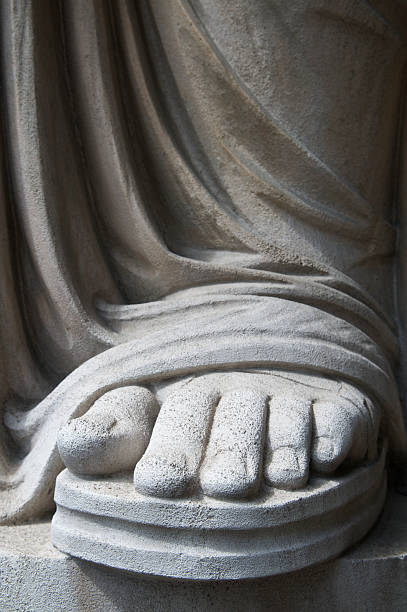 istock Foot and Sandal in Weathered White Stone 184282466