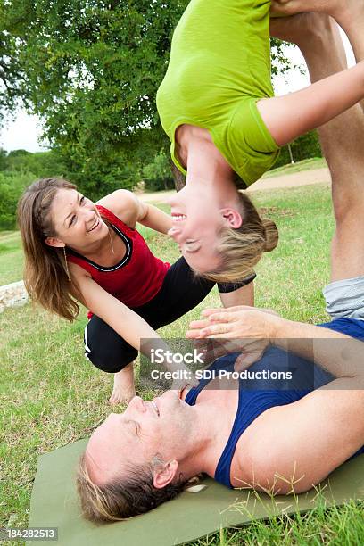 Foto de Acroyoga Instrutor Ajudando O Homem E Jovem Mulher Com Uma Pose e mais fotos de stock de Acroyoga