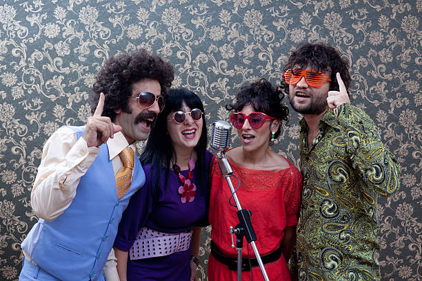 istock Four people in seventies style singing on old fashioned microphone 184282699