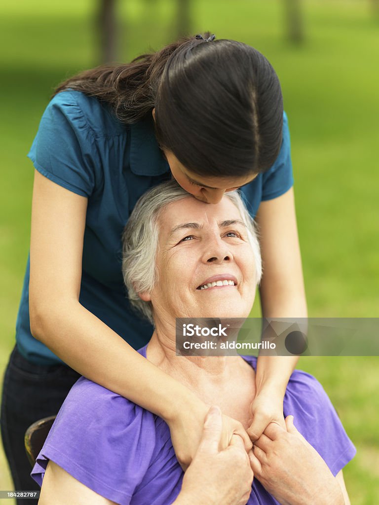 Loving grandchild kissing her grandmother 70-79 Years Stock Photo