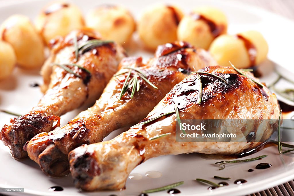 Roast chicken with potatoes on a plate American Culture Stock Photo