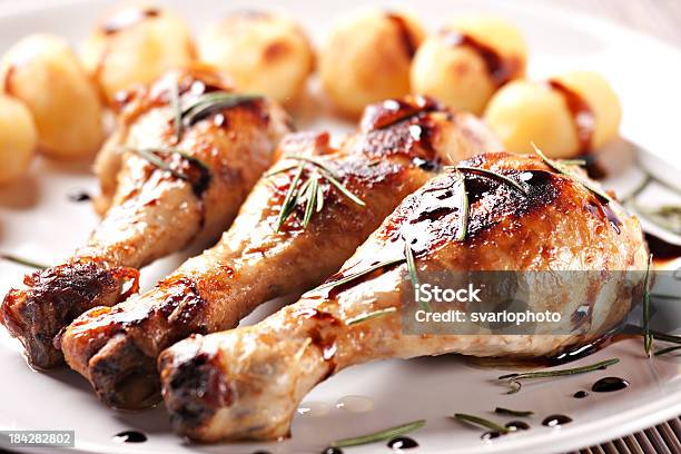 Roast Chicken With Potatoes On A Plate Stock Photo - Download Image Now - American Culture, Animal Body Part, Animal Leg