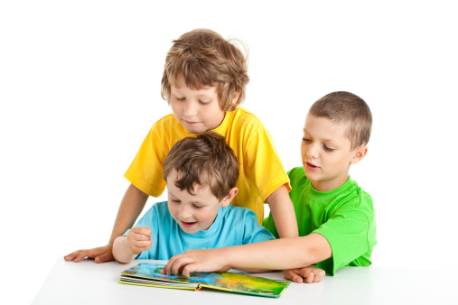 three boys reading book isolated on white