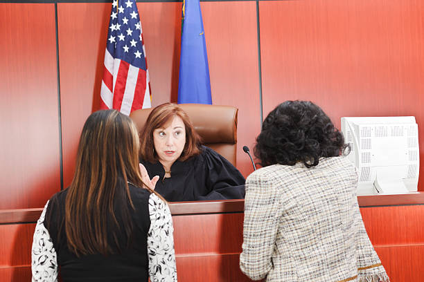 Lawyers Speaking With Judge in Courtroom stock photo