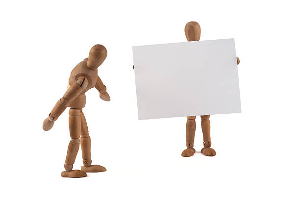 istock Wooden Mannequin holding blank sign 184283121