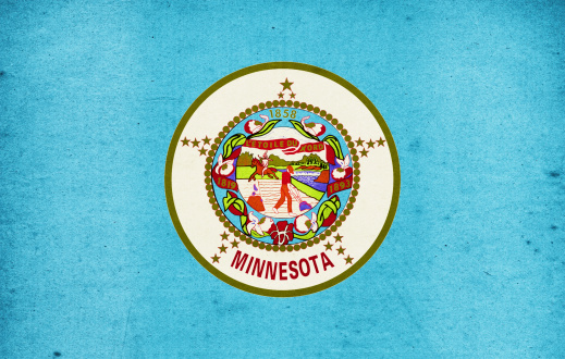 US state of Minnesota paper flag close up with light effect and vignette. Visible paper texture for super realistic effect. Selective focus. Canon 5D Mark II and Sigma lens.SEE MORE US STATE FLAGS BELOW: