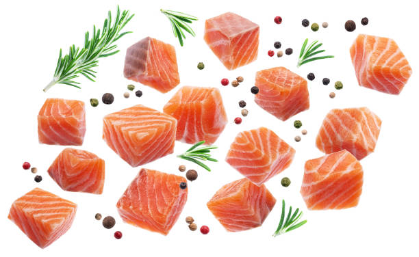 istock Salmon cubes and spices flying in air on white background. File clipping paths. 1842833535