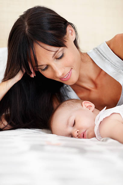 istock Woman with sleeping daughter 184283394