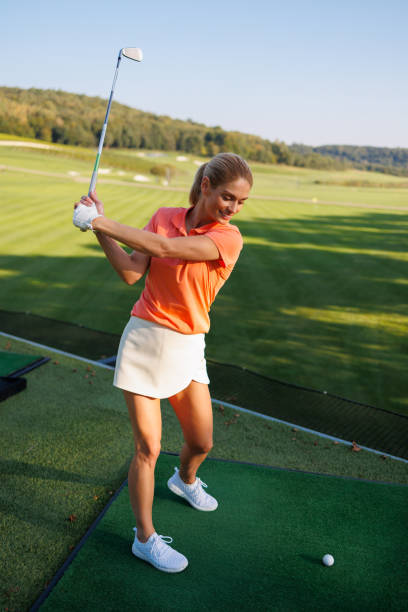 istock Determined Young Lady Golfer Swinging 1842834068