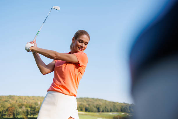 istock Focused Lady Golfer Tees Off 1842834069
