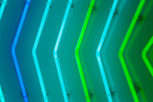 Detail of neon sign with green and blue lamps.