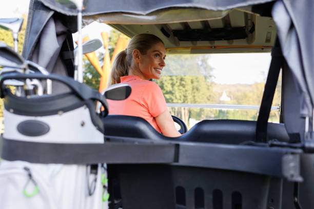 istock Blonde Golfer Adventuring via Golf Cart 1842840933