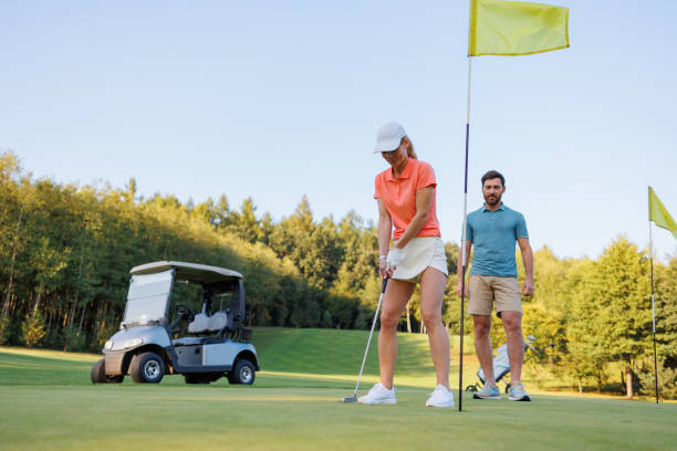 istock Focused Drive on Last Hole: Young Couple in Golf Match 1842841449