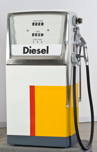 Cropped picture of a hand filling up car tank on gas station.