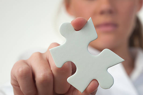 istock Woman holding jigsaw puzzle piece 184285070