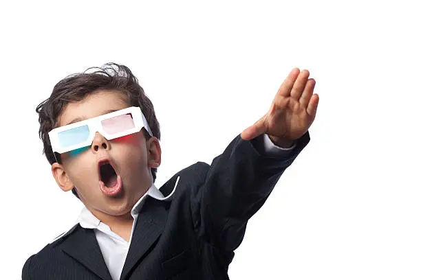 Photo of Excited child with 3-D glasses watching three-D film