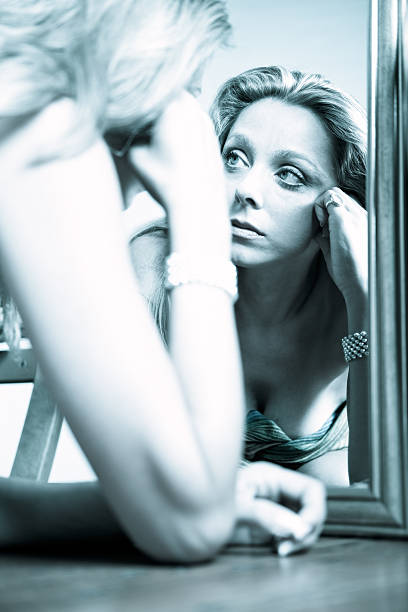 istock Woman looking at the mirror 184285416