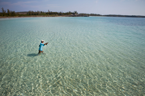 Man fly fishing for bonefish in the Caribbean.