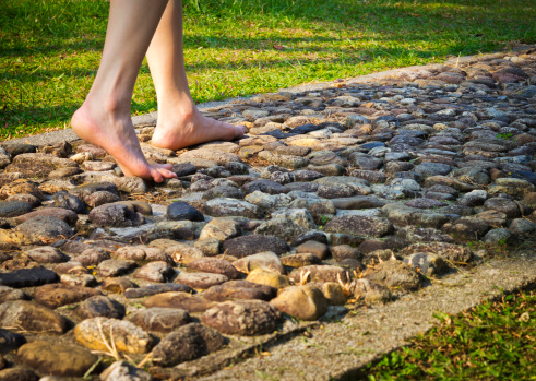Woman walking on stone path at the park