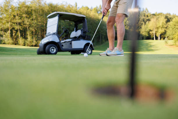 istock Scenic Golf Course: Golfer with Cart and Hole 1842863661