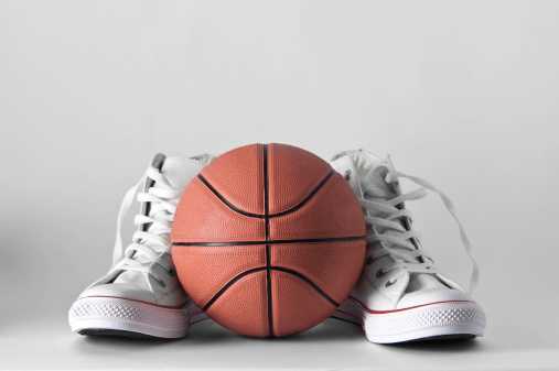 Basketball between sport shoes...