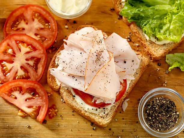 Preparing a Turkey Sandwich "Preparing a Turkey Sandwich with Lettuce, Tomato, Mayo and Fresh Ground Pepper -Photographed on Hasselblad H3D2-39mb Camera" southern turkey stock pictures, royalty-free photos & images