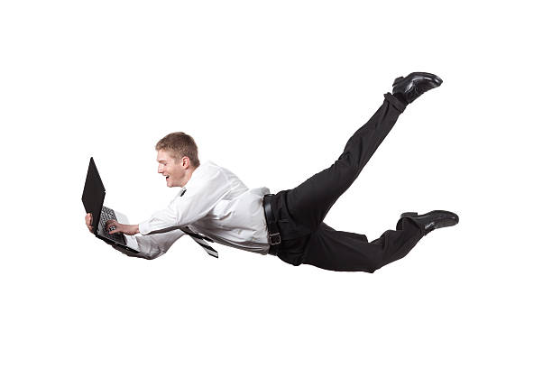 istock Businessman using a laptop in mid-air 184287123